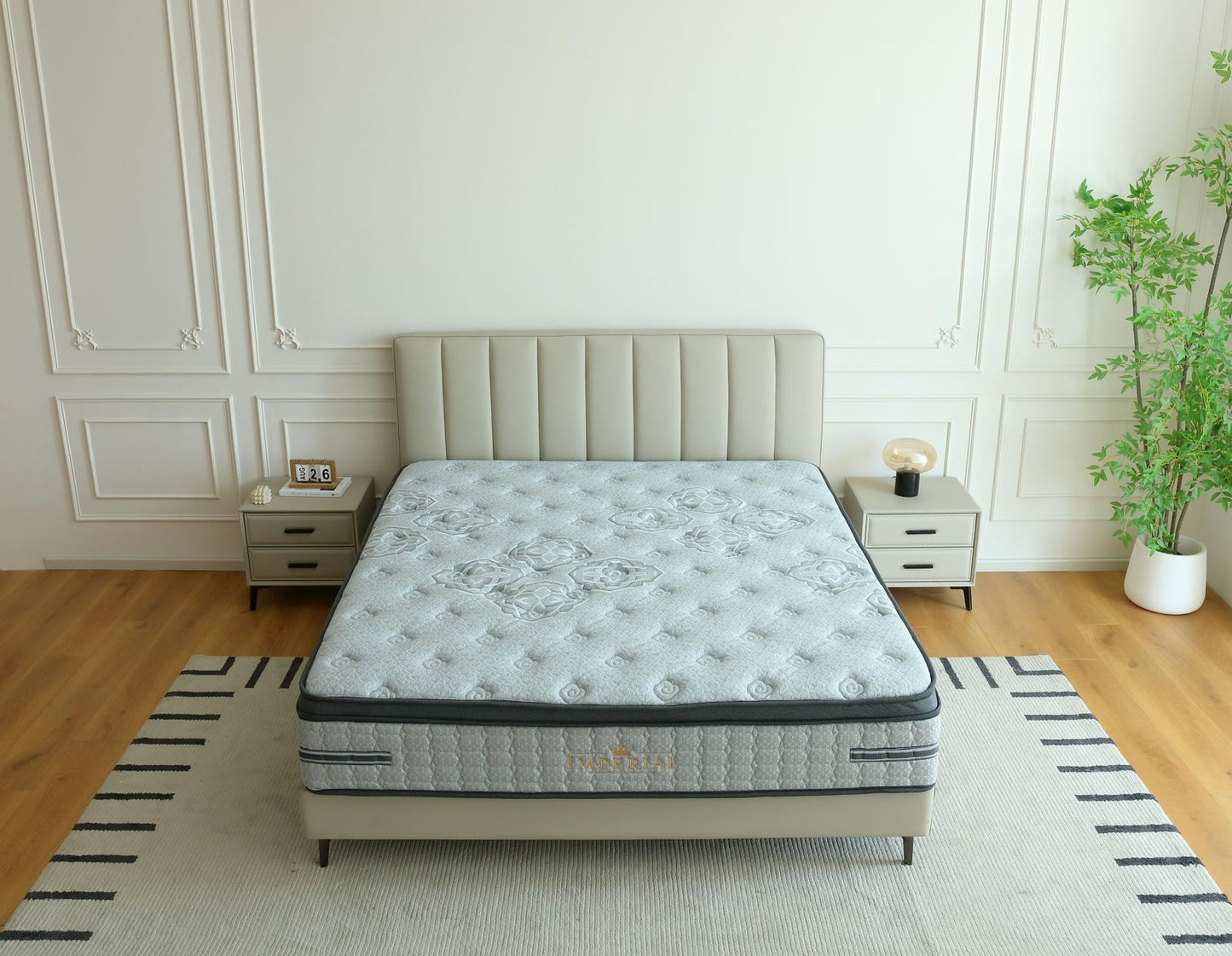 Matelas Imperial vu du dessus sur son lit, entre deux tables de chevet et une plante verte