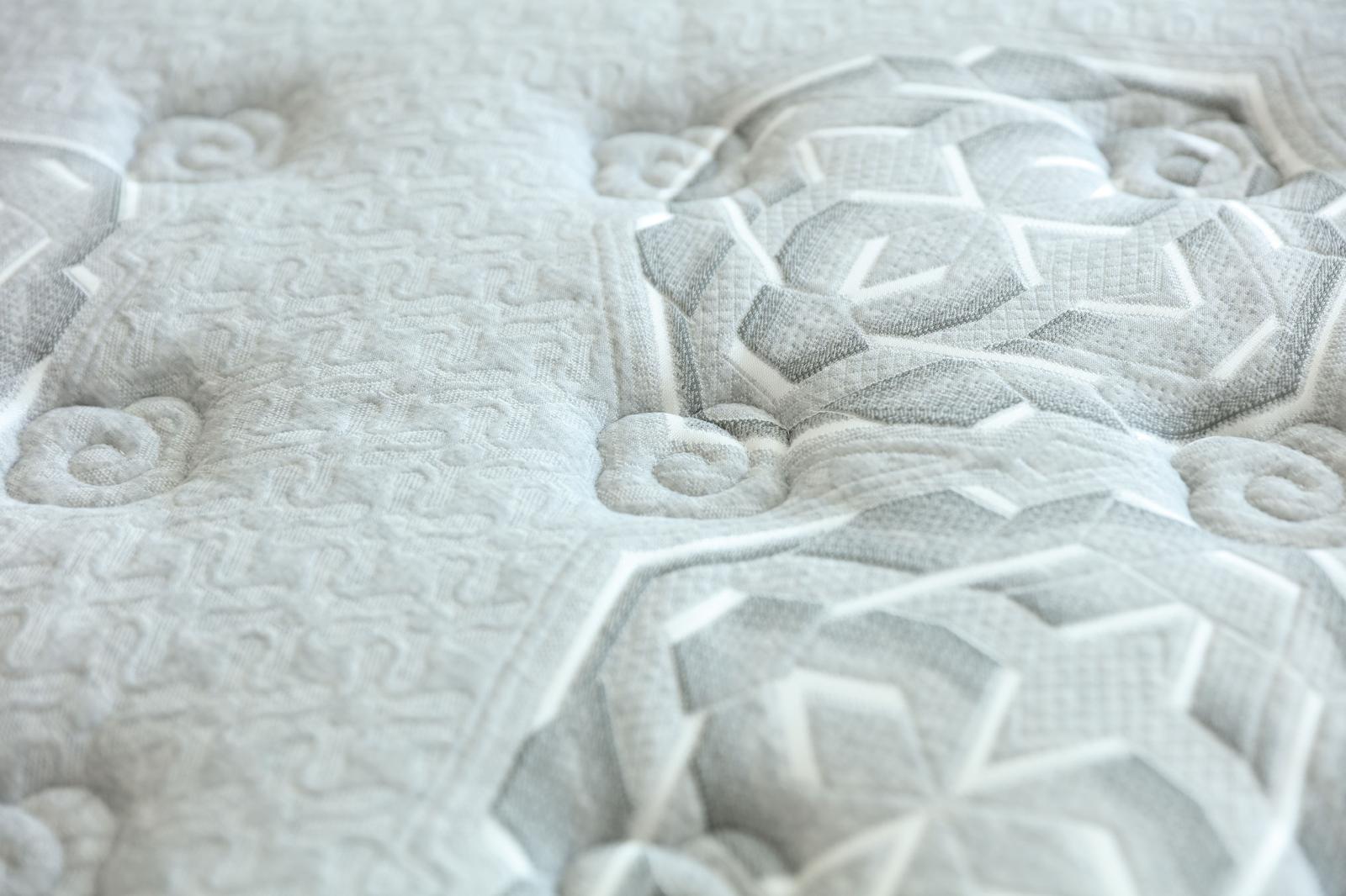 Gros plan sur le motif floral matelassé du coutil du matelas Imperial